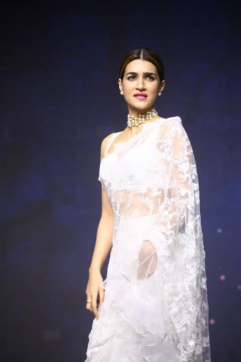 Kriti Sanon Charming Stills In White Saree Sleeveless Blouse